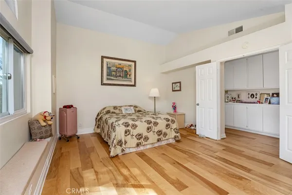 a bedroom with a large bed and a chandelier