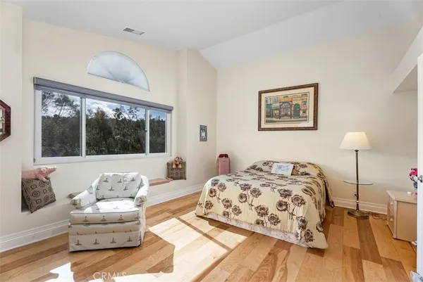 a bedroom with a bed and a couch with window
