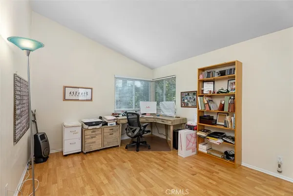 a view of a workspace with furniture and a window