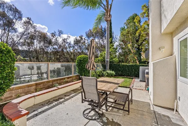 a view of patio with a table and chairs and potted plants