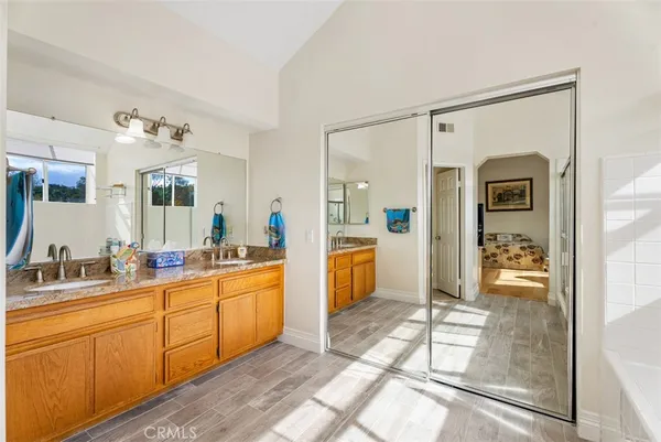 a large bathroom with a glass door shower and sink