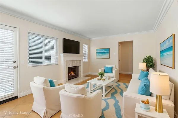 a living room with furniture a fireplace and a flat screen tv