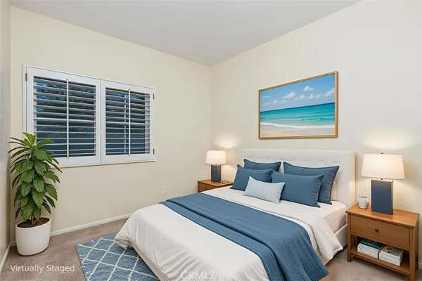 a bedroom with a bed and a potted plant