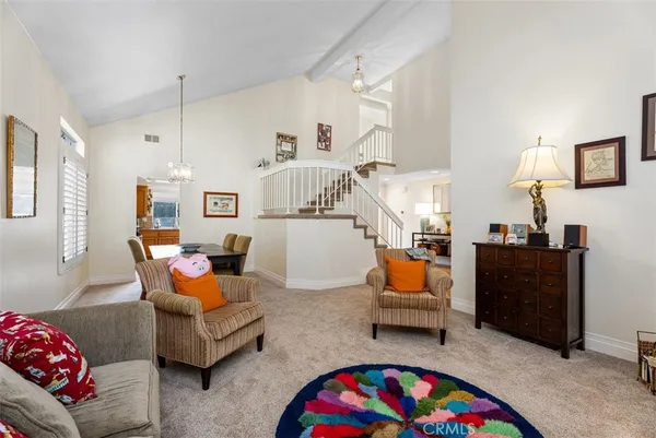 a living room with furniture and kitchen view