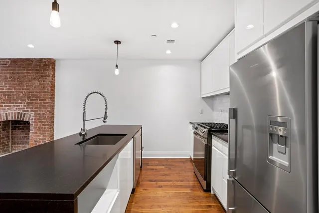 a bathroom with a granite countertop sink a shower and a mirror