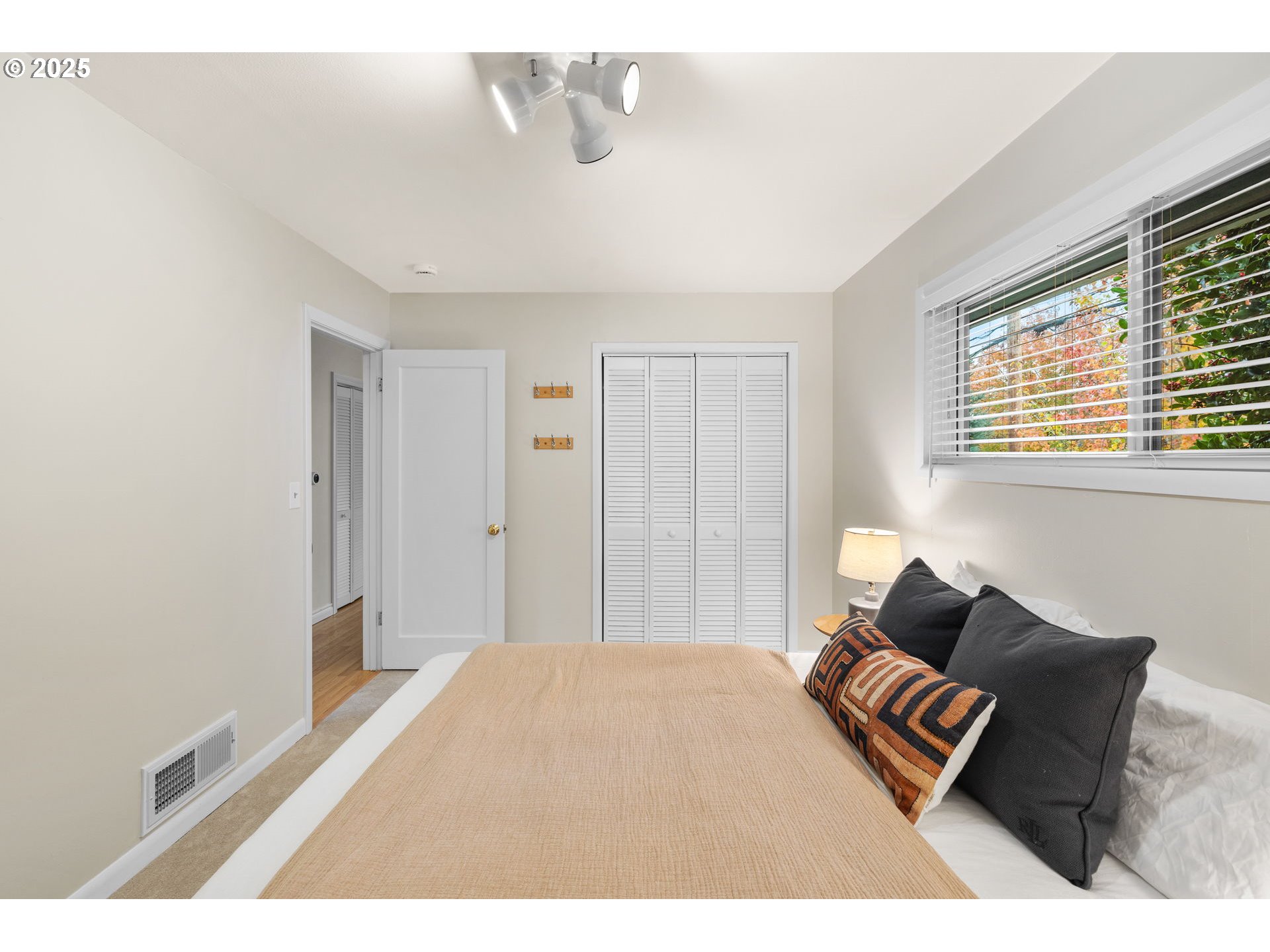 7643 Southeast Market Street Portland, OR 97215 - Photo 11 of 34 a bedroom with a bed and wooden floor