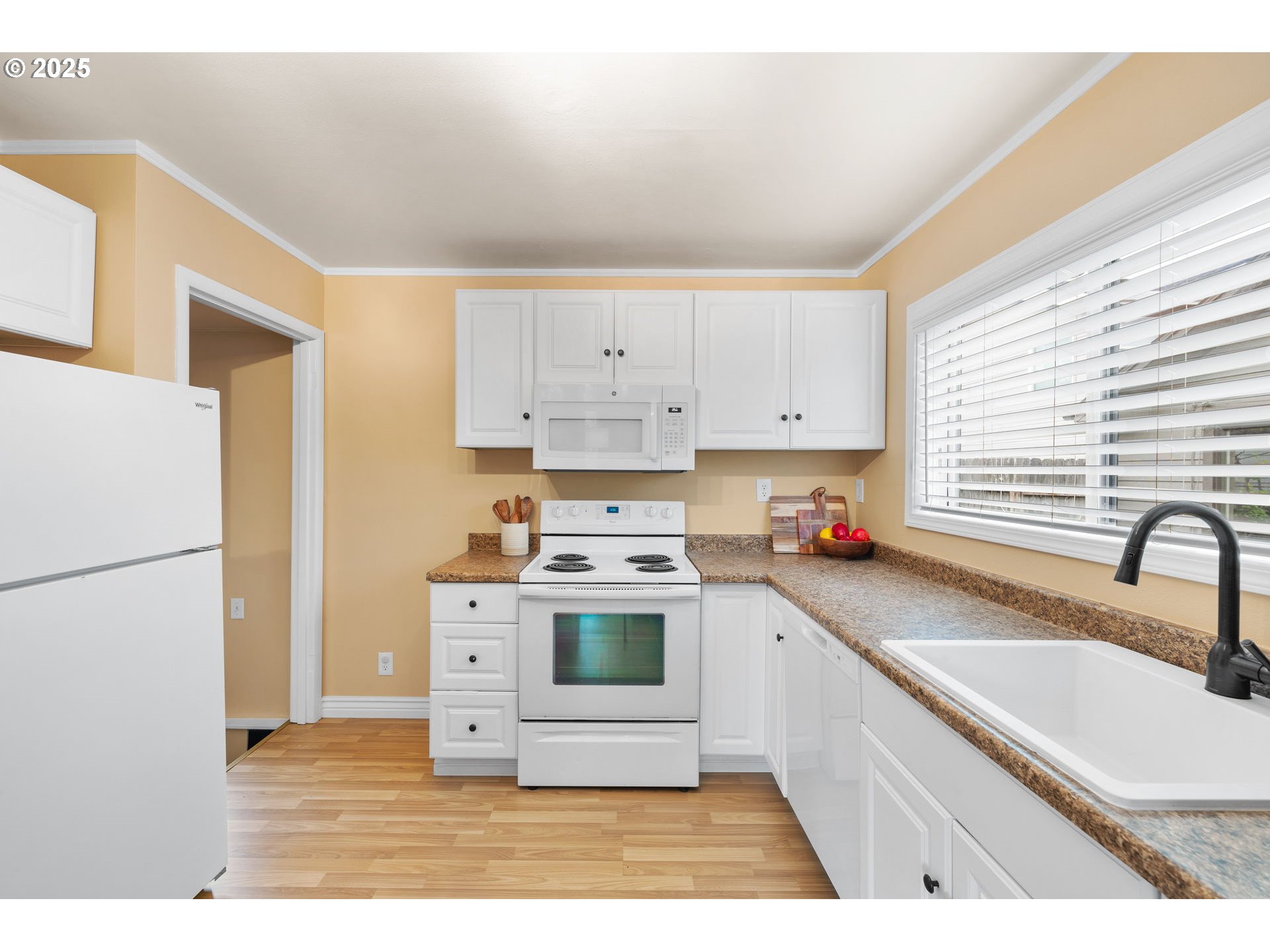 7643 Southeast Market Street Portland, OR 97215 - Photo 16 of 34 a kitchen with a stove a sink and a refrigerator