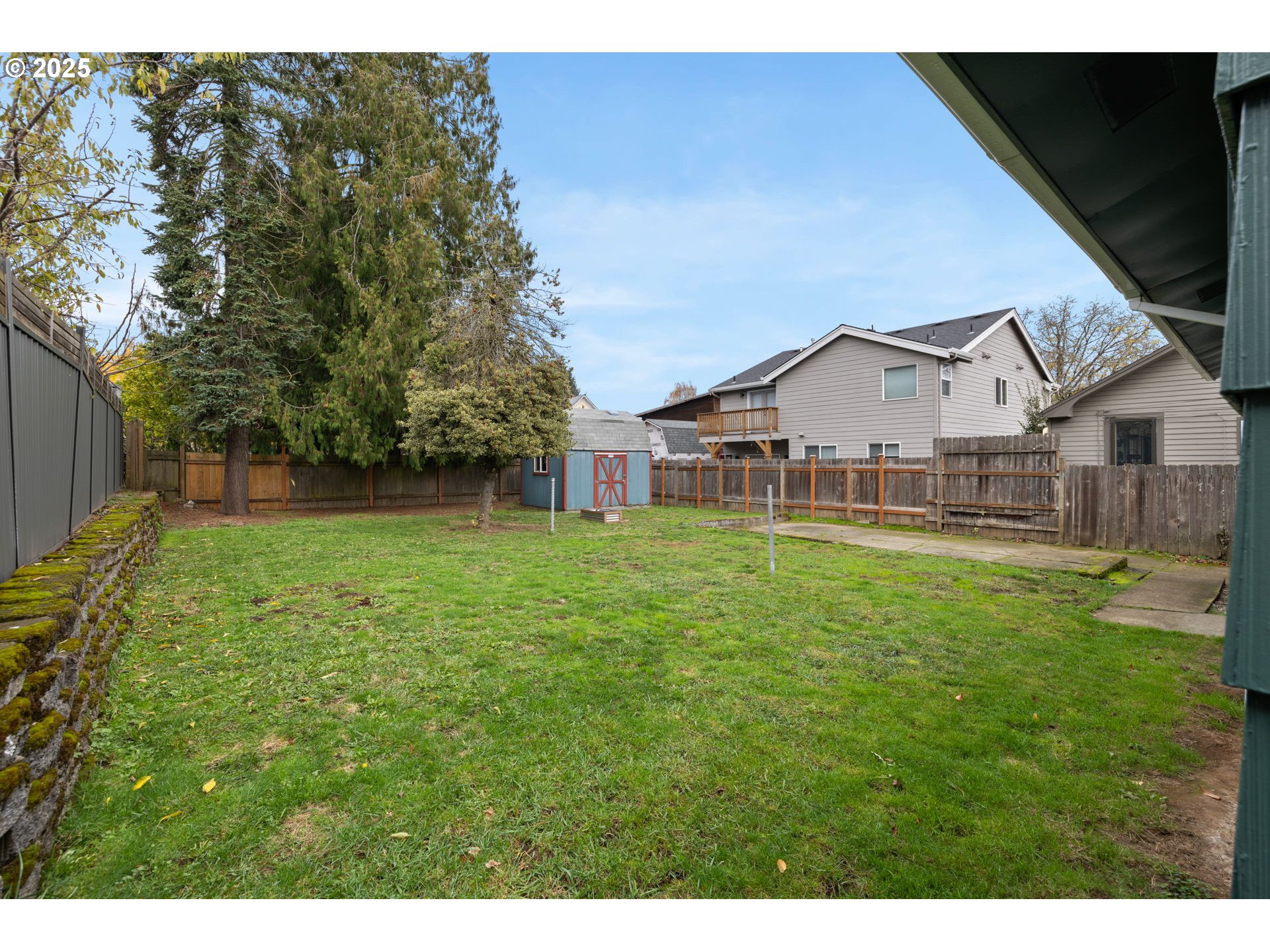 7643 Southeast Market Street Portland, OR 97215 - Photo 29 of 34 a view of a house with a big yard and large trees