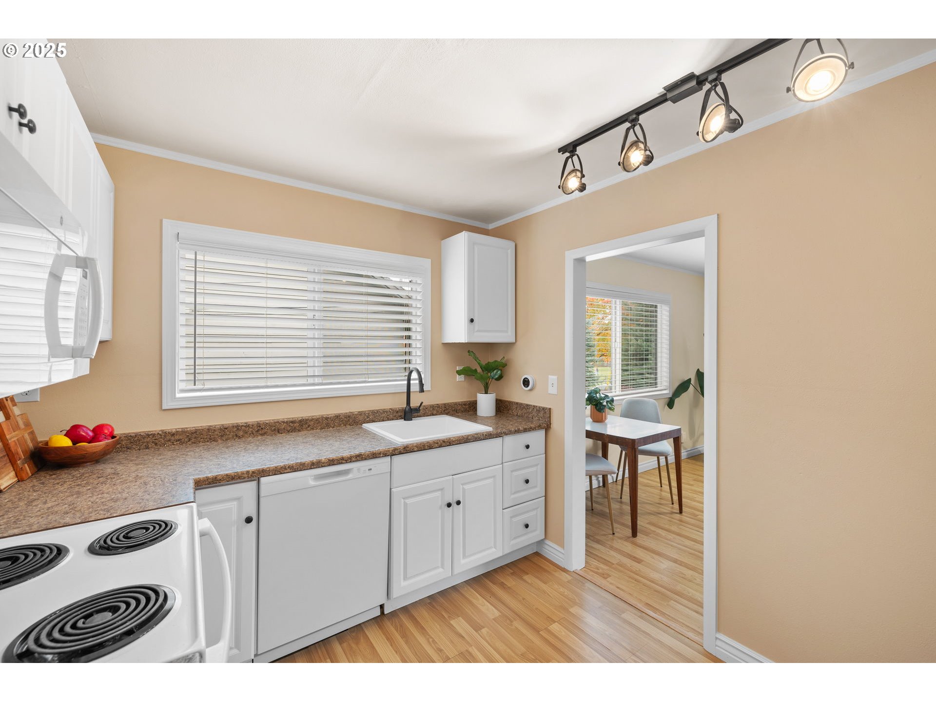 7643 Southeast Market Street Portland, OR 97215 - Photo 6 of 34 a kitchen with granite countertop a stove a sink and a refrigerator