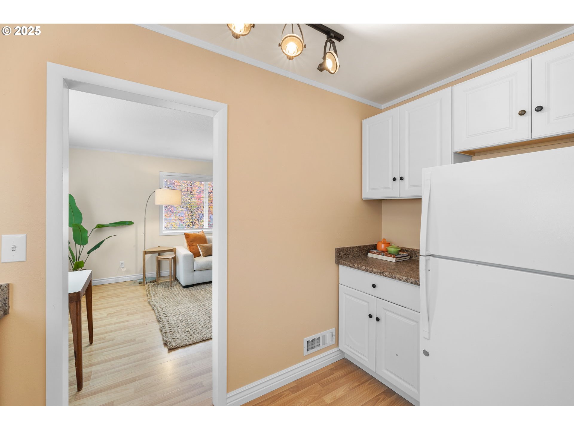 7643 Southeast Market Street Portland, OR 97215 - Photo 7 of 34 a kitchen with a refrigerator and white cabinets