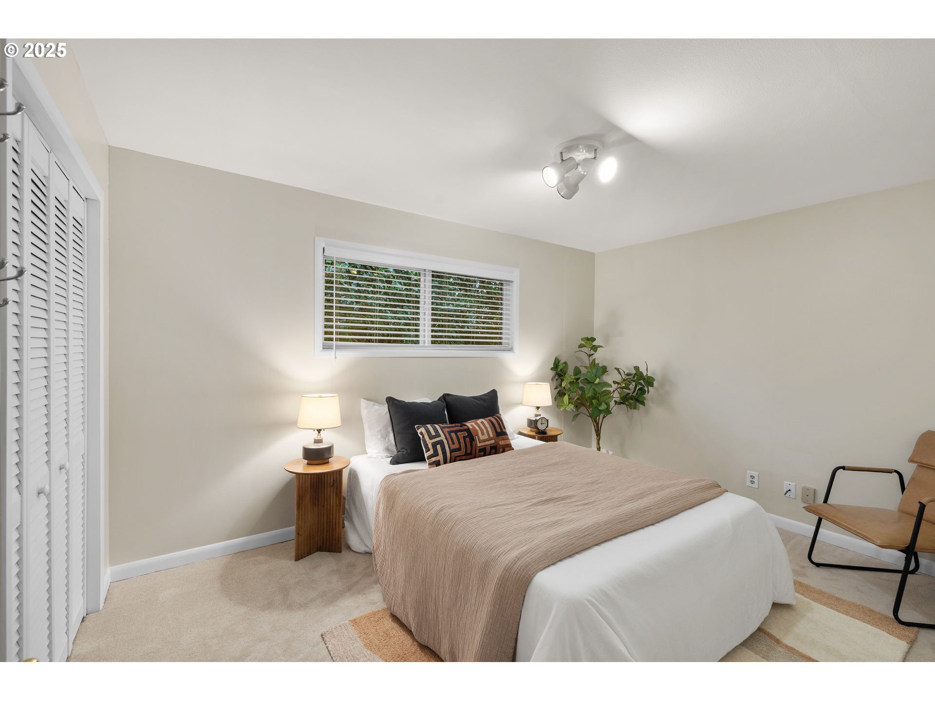 7643 Southeast Market Street Portland, OR 97215 - Photo 10 of 34 a bedroom with a large bed and a potted plant