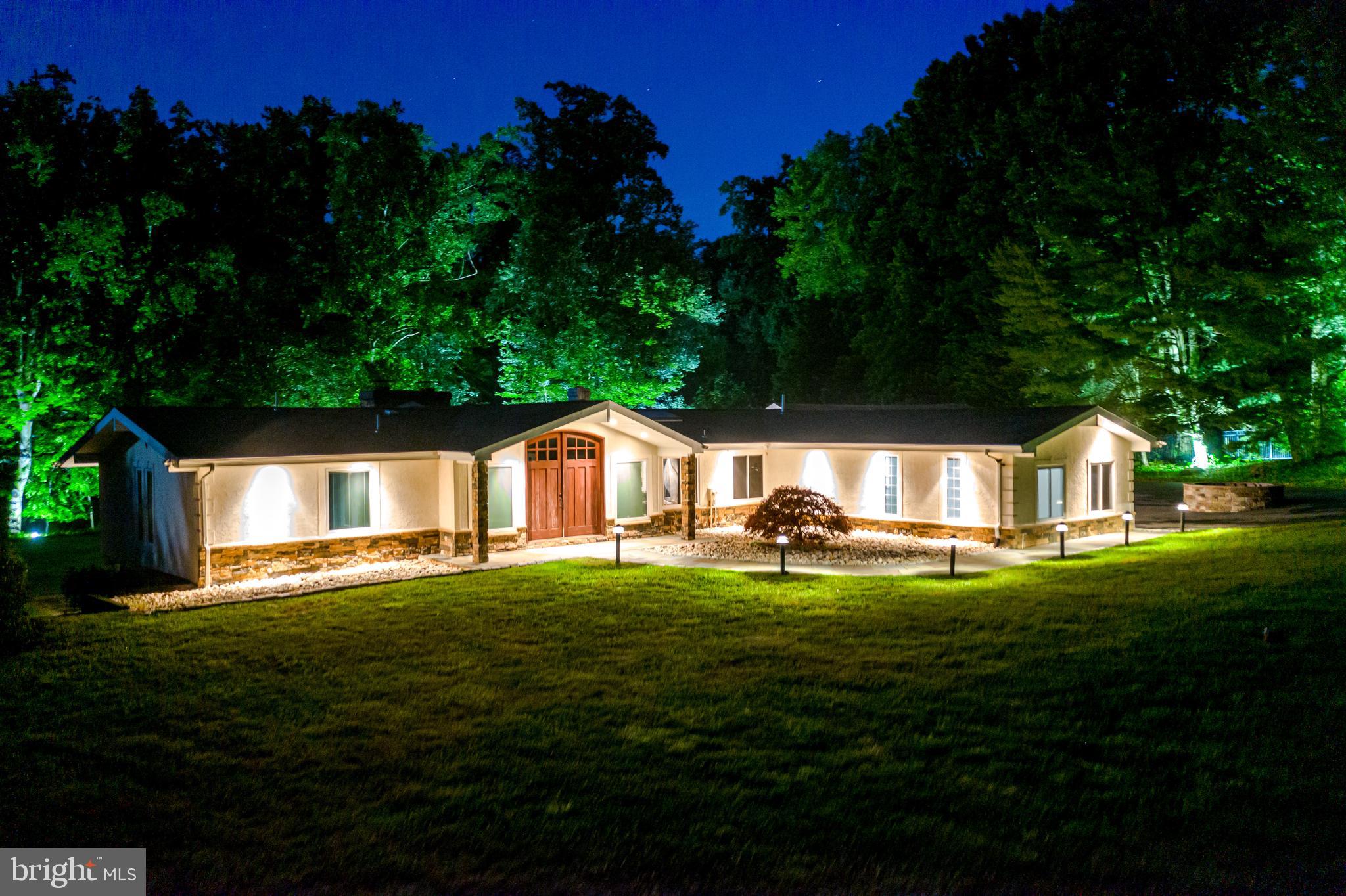 5402 Kennett Pike Wilmington, DE 19807 - Photo 2 of 81 a front view of a house with a yard and trees