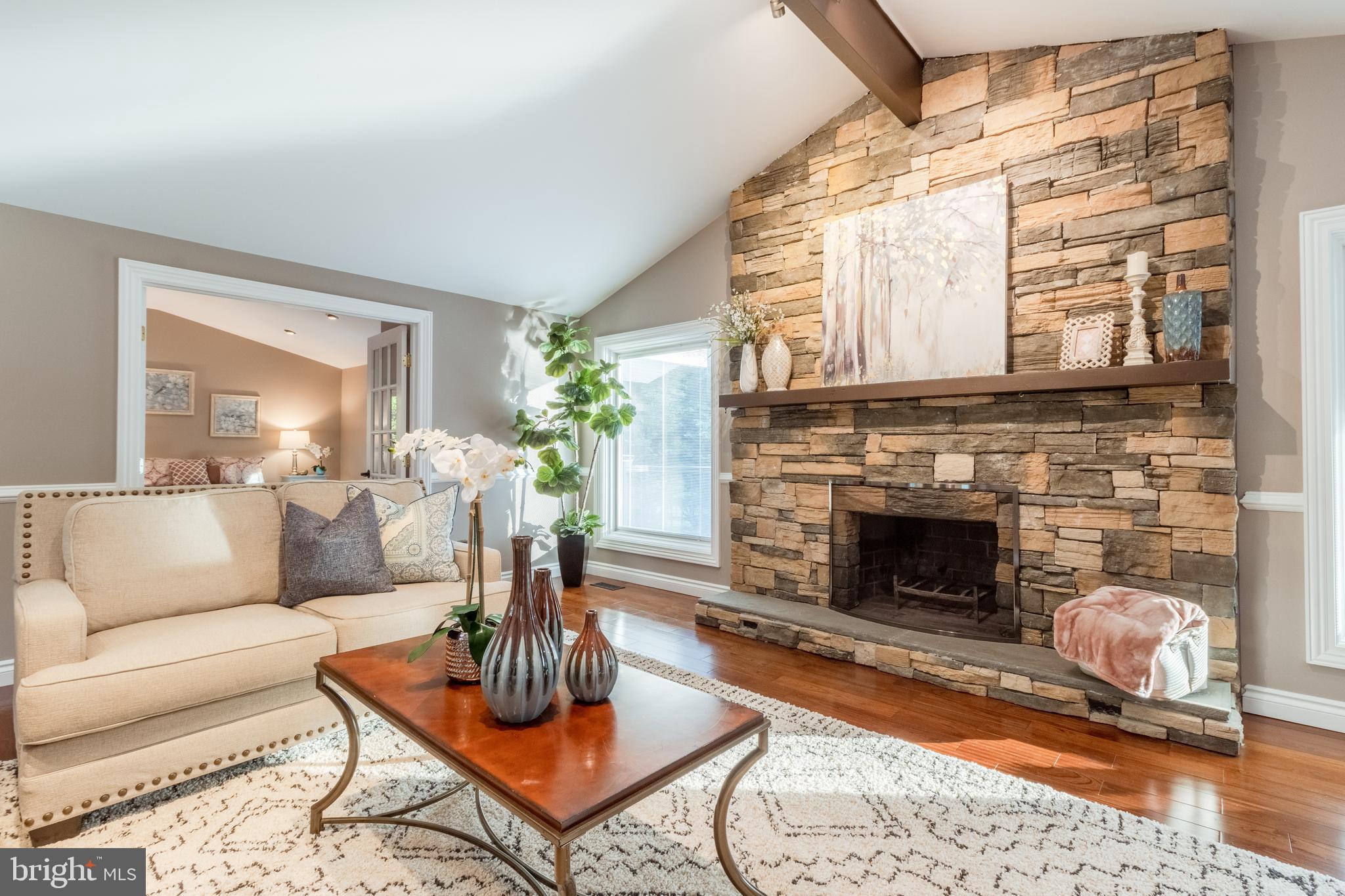 5402 Kennett Pike Wilmington, DE 19807 - Photo 15 of 81 a living room with furniture a fireplace and a table