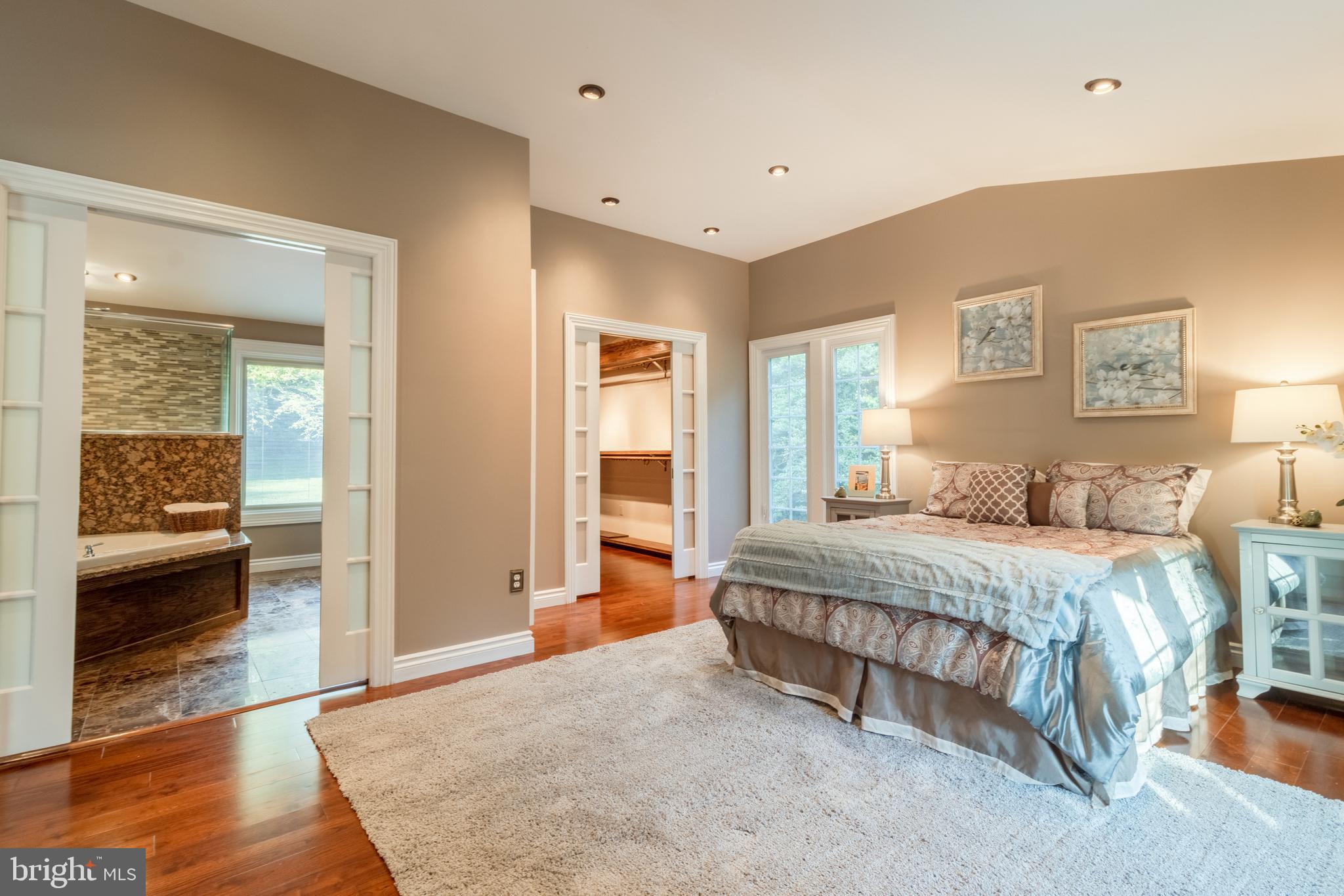 5402 Kennett Pike Wilmington, DE 19807 - Photo 31 of 81 a spacious bedroom with a large bed and a walk in closet