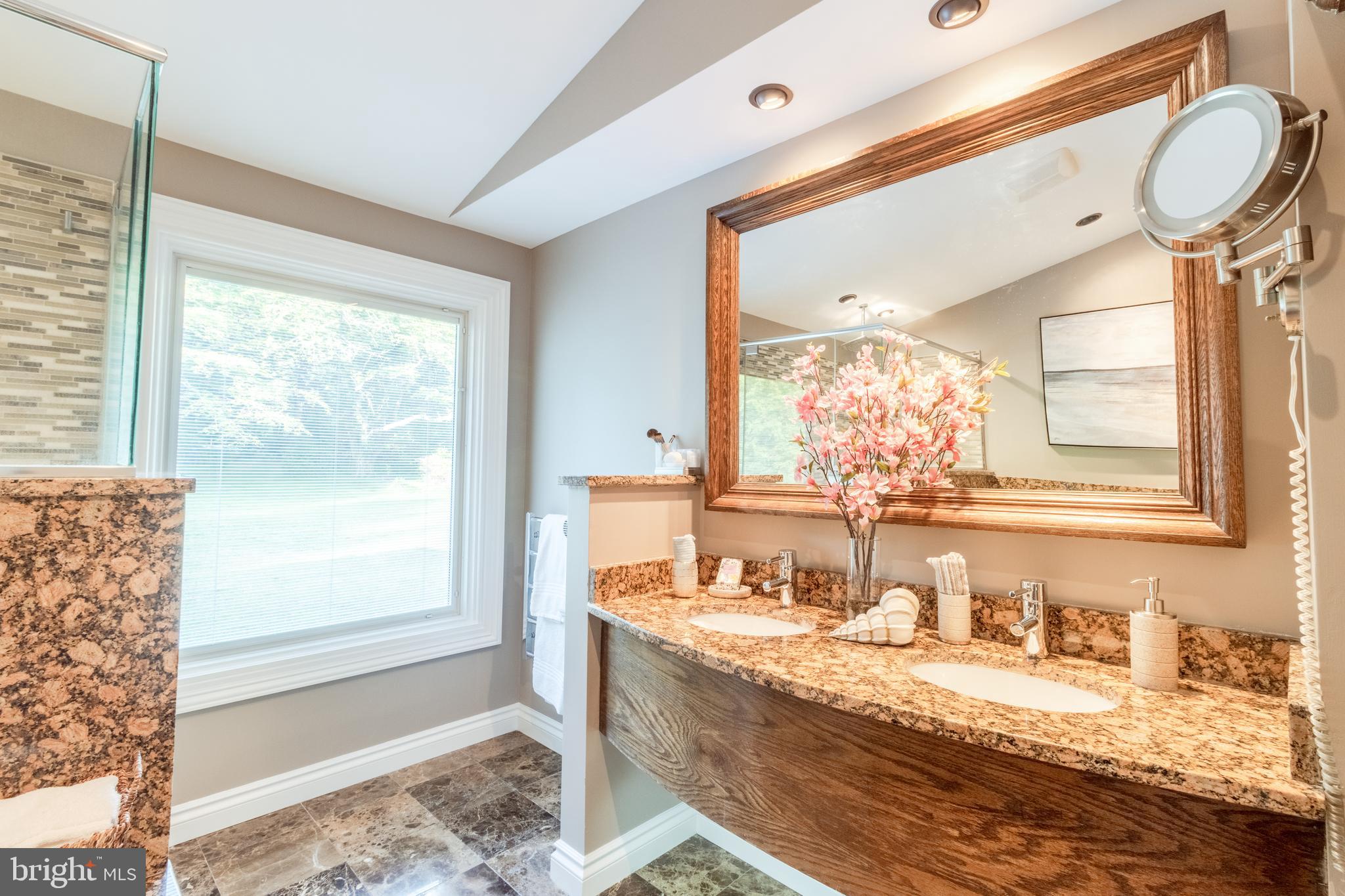 5402 Kennett Pike Wilmington, DE 19807 - Photo 37 of 81 a bathroom with a granite countertop sink mirror vanity and bathtub
