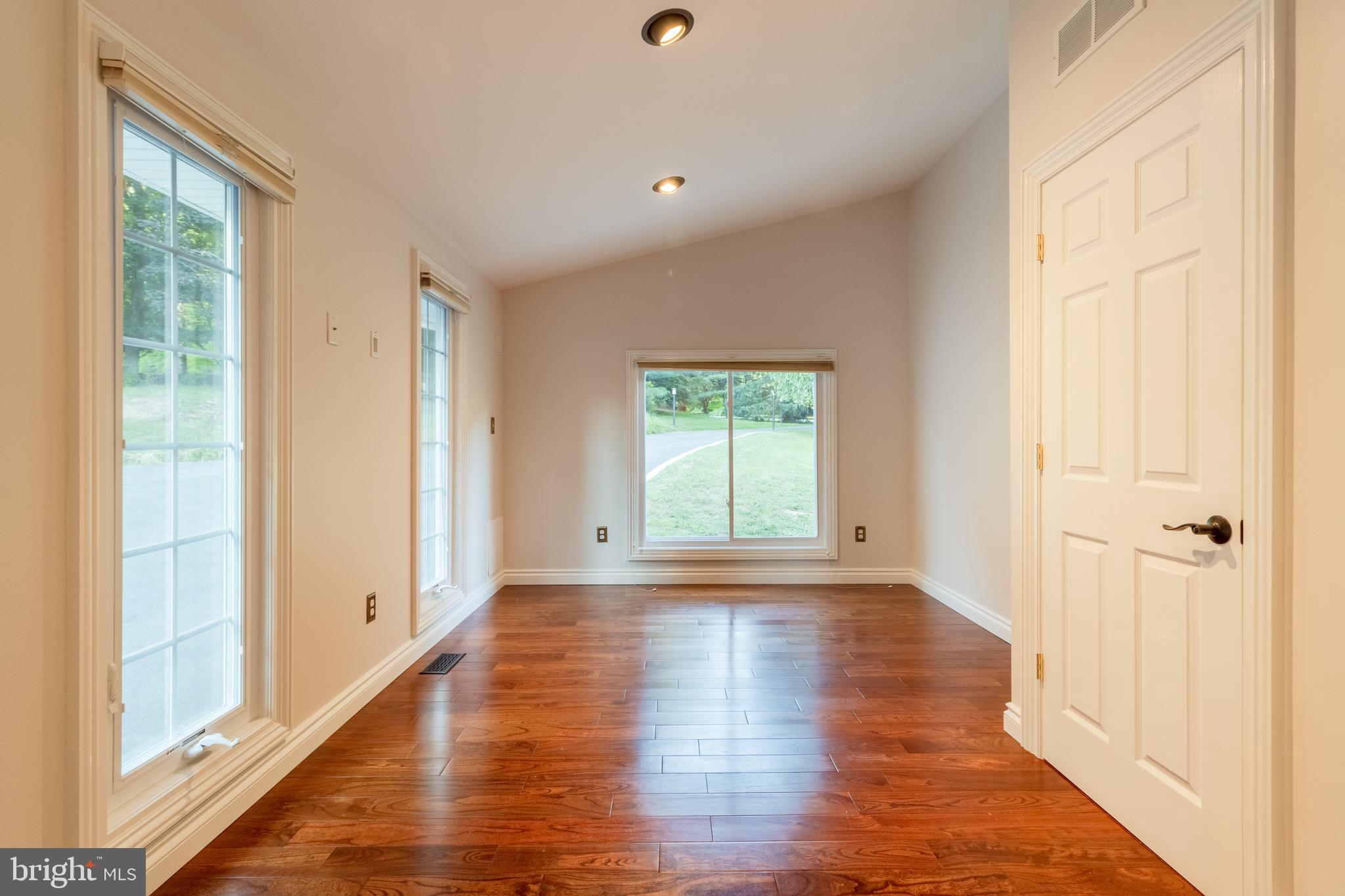 5402 Kennett Pike Wilmington, DE 19807 - Photo 47 of 81 a view of an empty room with wooden floor and a window