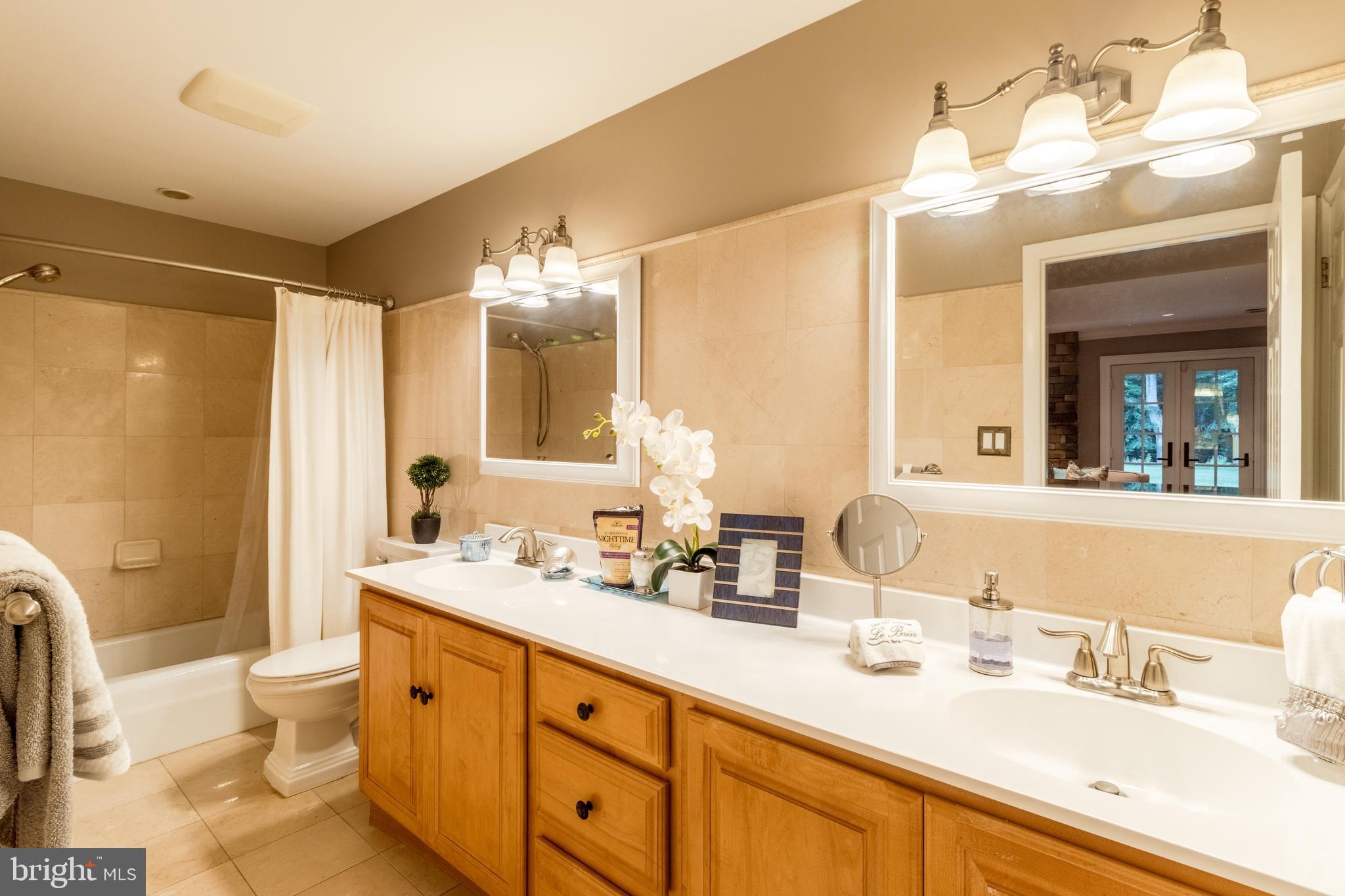 5402 Kennett Pike Wilmington, DE 19807 - Photo 61 of 81 a bathroom with a double vanity sink toilet mirror and shower