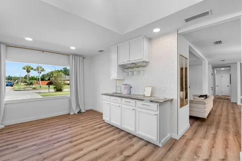 a open kitchen with stainless steel appliances granite countertop a lot of counter space and wooden floors