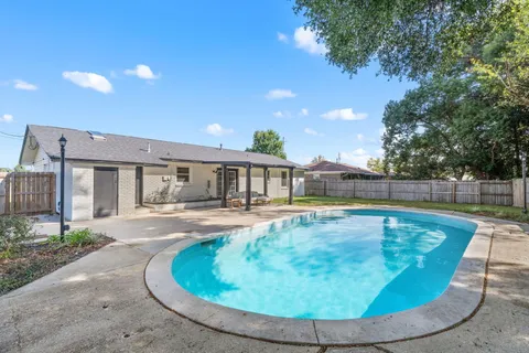 a view of a swimming pool with a patio