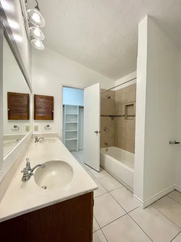 a view of a patio with a table and chairs under an umbrella