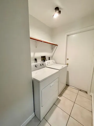 a view of a house with a yard and tree