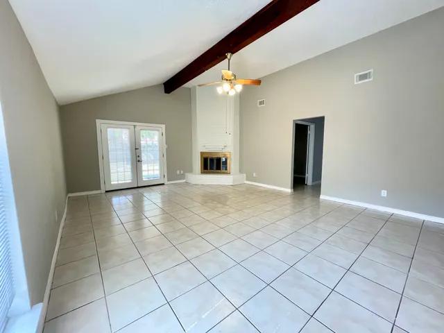 a view of a livingroom with an empty space and a window