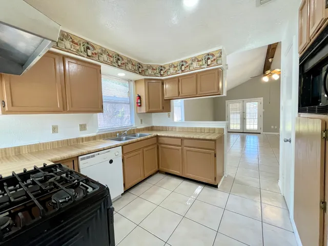 a kitchen with a stove a sink and a refrigerator