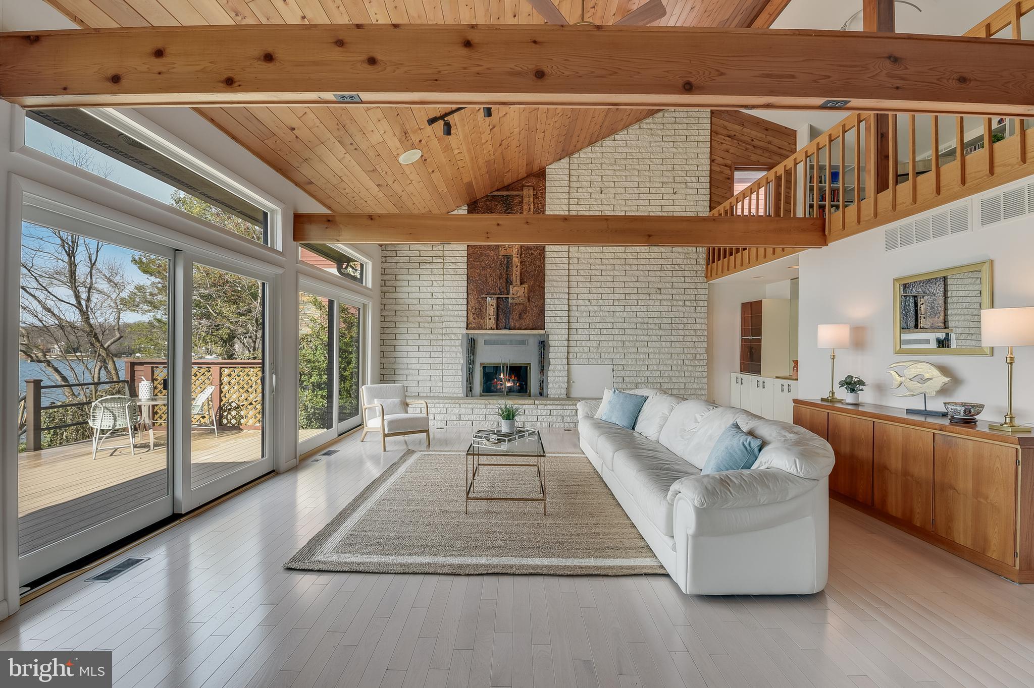 245 Long Point Road Crownsville, MD 21032 - Photo 15 of 53 a living room with furniture large windows and wooden floor