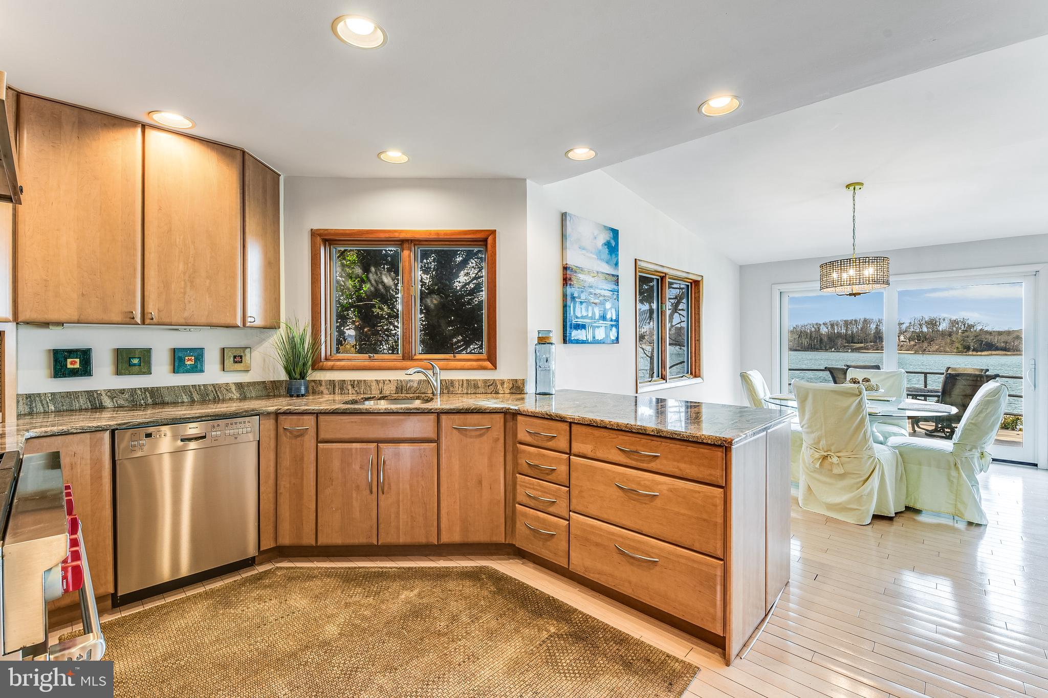 245 Long Point Road Crownsville, MD 21032 - Photo 23 of 53 a kitchen with a sink dining table and chairs