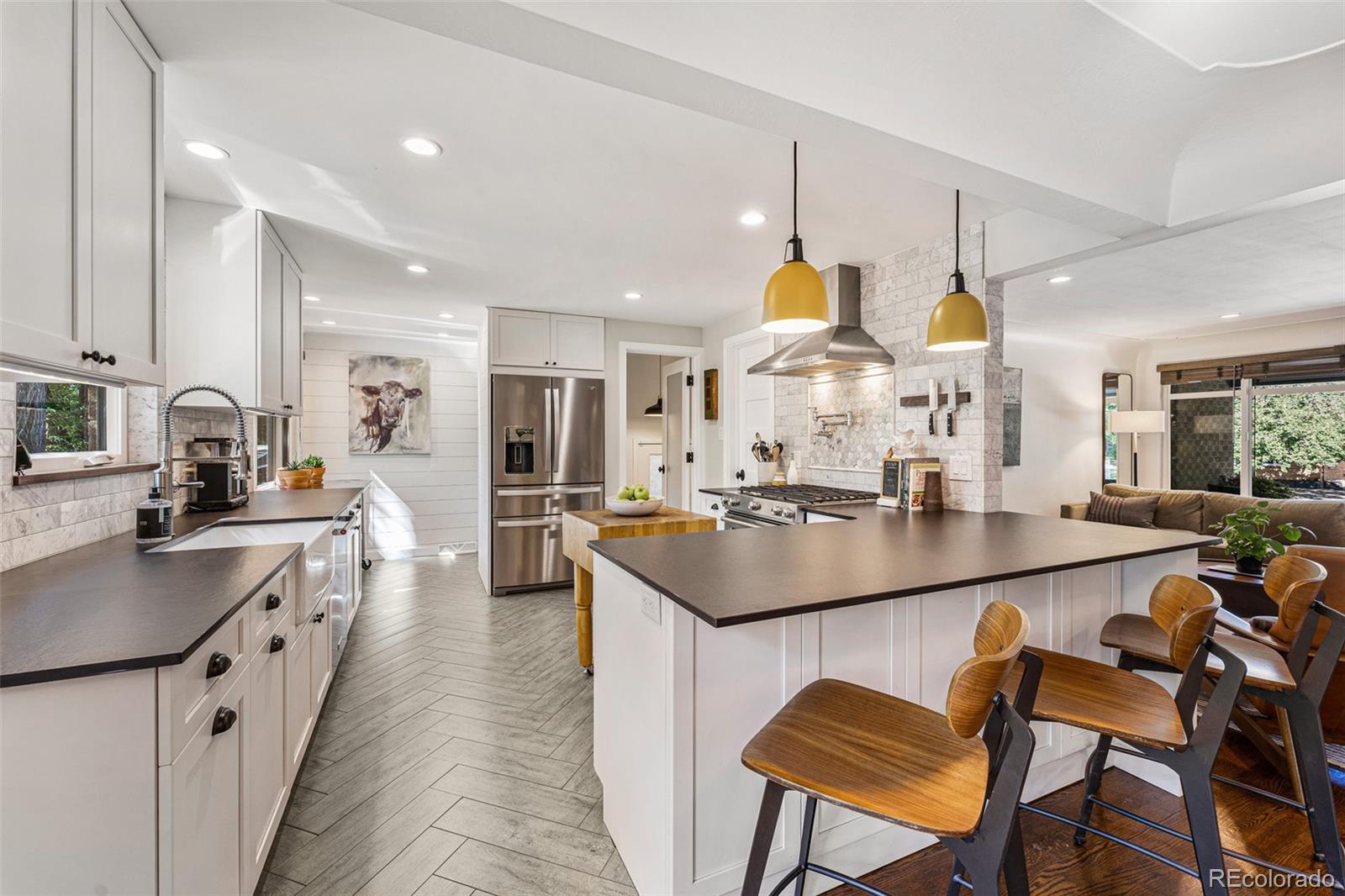 3885 Cody Street Wheat Ridge, CO 80033 - Photo 13 of 40 a kitchen with counter and chairs