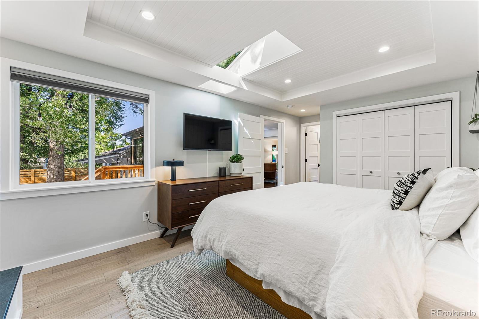 3885 Cody Street Wheat Ridge, CO 80033 - Photo 20 of 40 a bedroom with a bed and a flat screen tv
