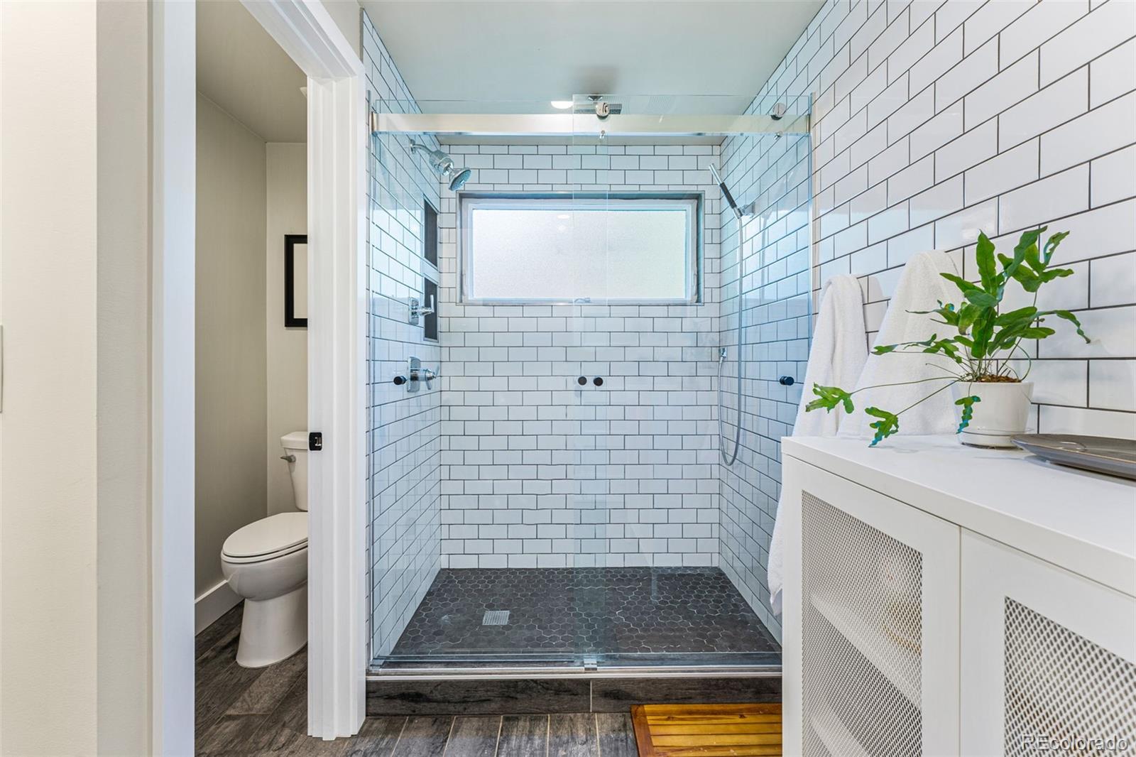 3885 Cody Street Wheat Ridge, CO 80033 - Photo 23 of 40 a bathroom with a sink a toilet and shower