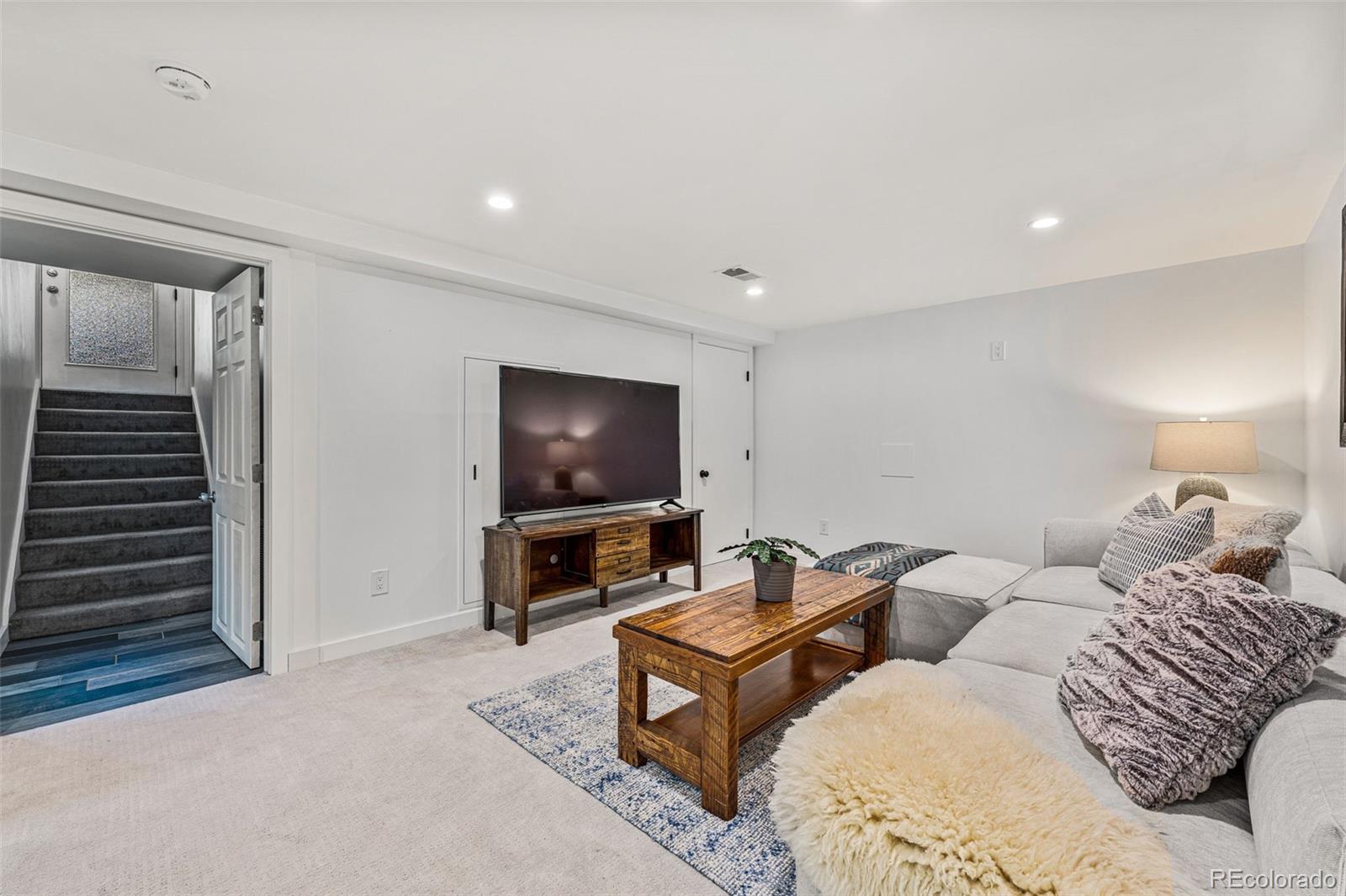3885 Cody Street Wheat Ridge, CO 80033 - Photo 26 of 40 a living room with furniture and a flat screen tv