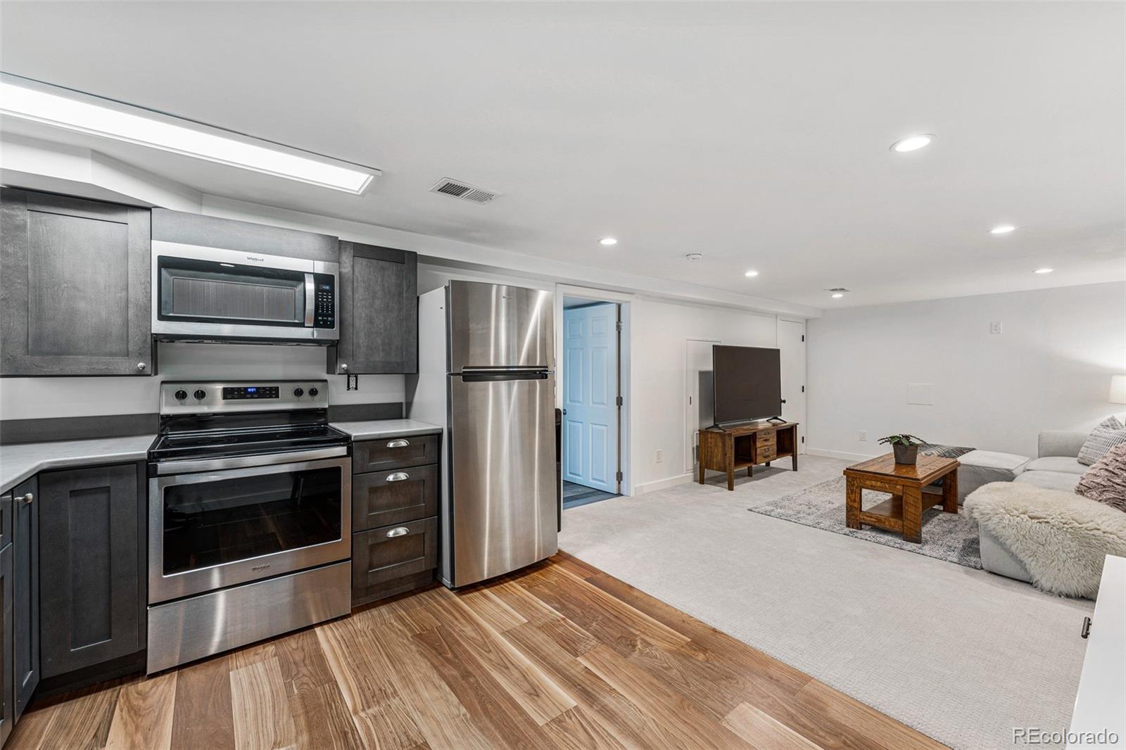 3885 Cody Street Wheat Ridge, CO 80033 - Photo 29 of 40 a kitchen with stainless steel appliances a stove a sink and a refrigerator