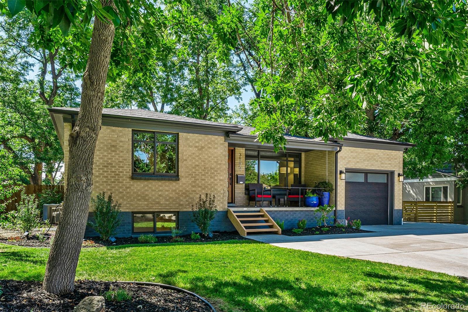 3885 Cody Street Wheat Ridge, CO 80033 - Photo 3 of 40 a front view of house with yard and green space