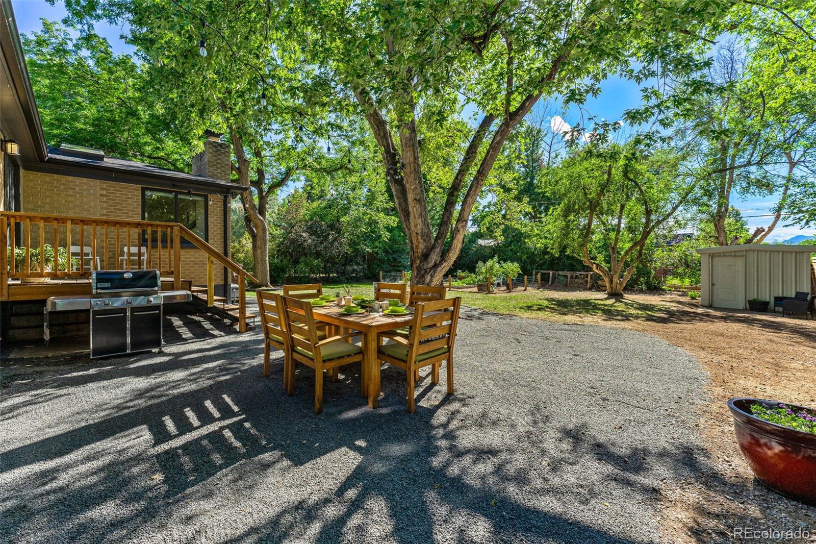 3885 Cody Street Wheat Ridge, CO 80033 - Photo 36 of 40 a view of a patio with table and chairs with wooden floor and fence