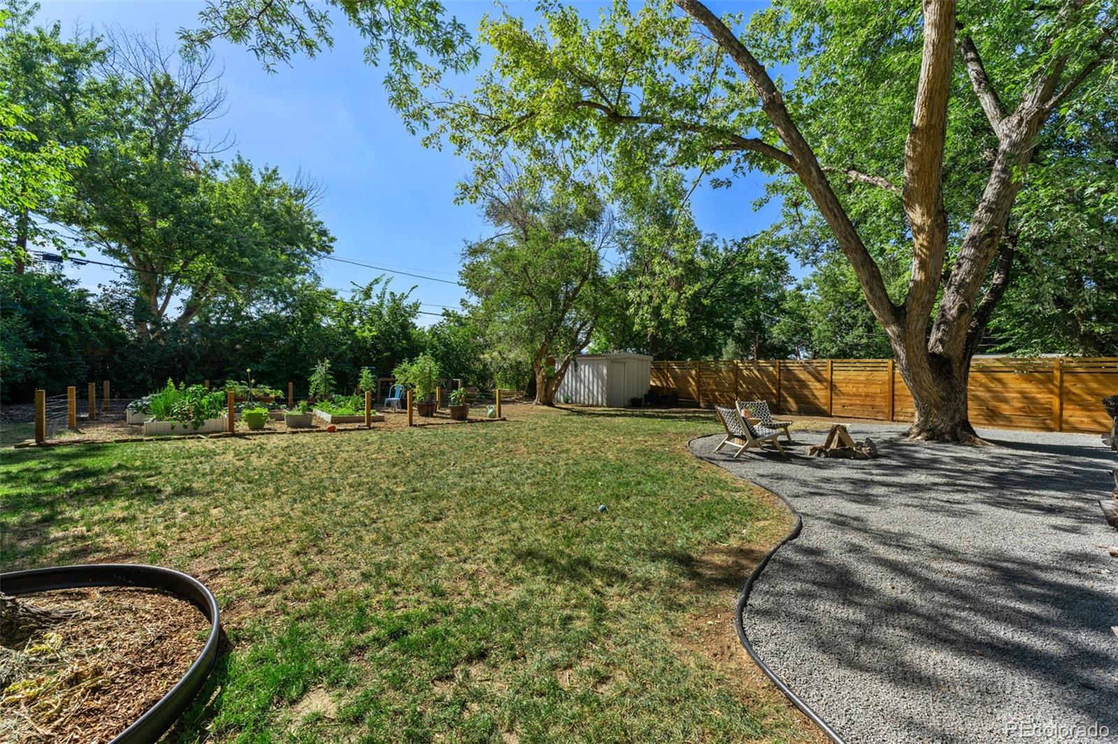 3885 Cody Street Wheat Ridge, CO 80033 - Photo 40 of 40 a view of a backyard with large trees