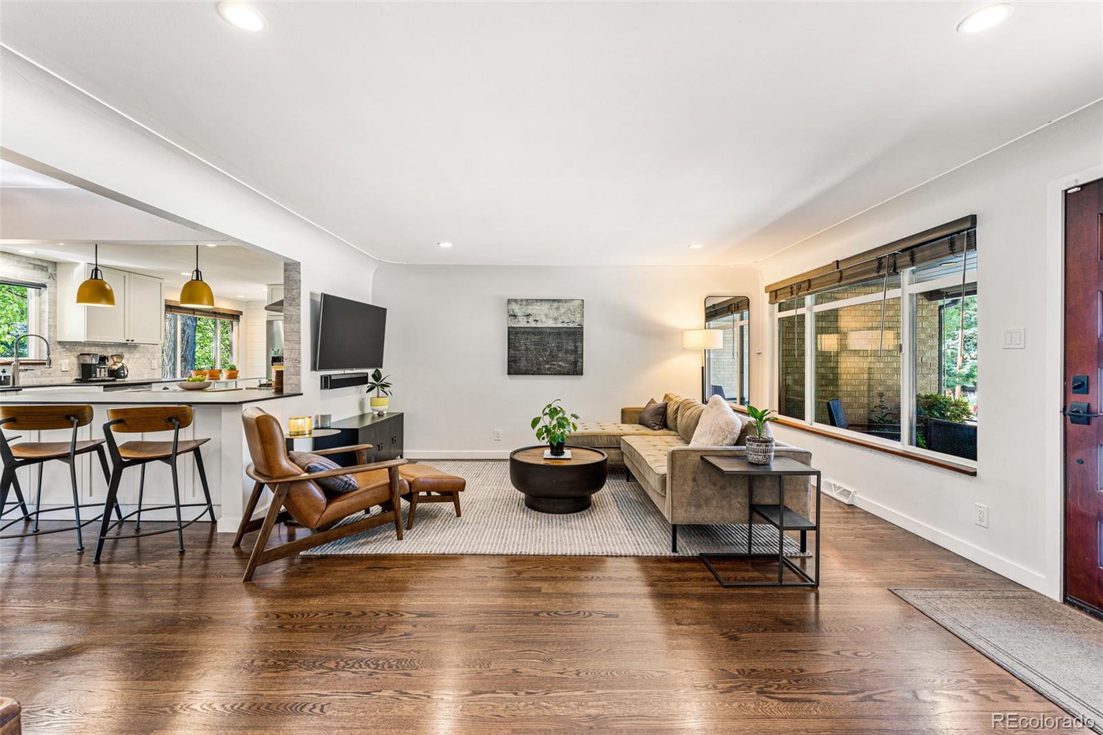 3885 Cody Street Wheat Ridge, CO 80033 - Photo 6 of 40 a living room with fireplace furniture and a wooden floor