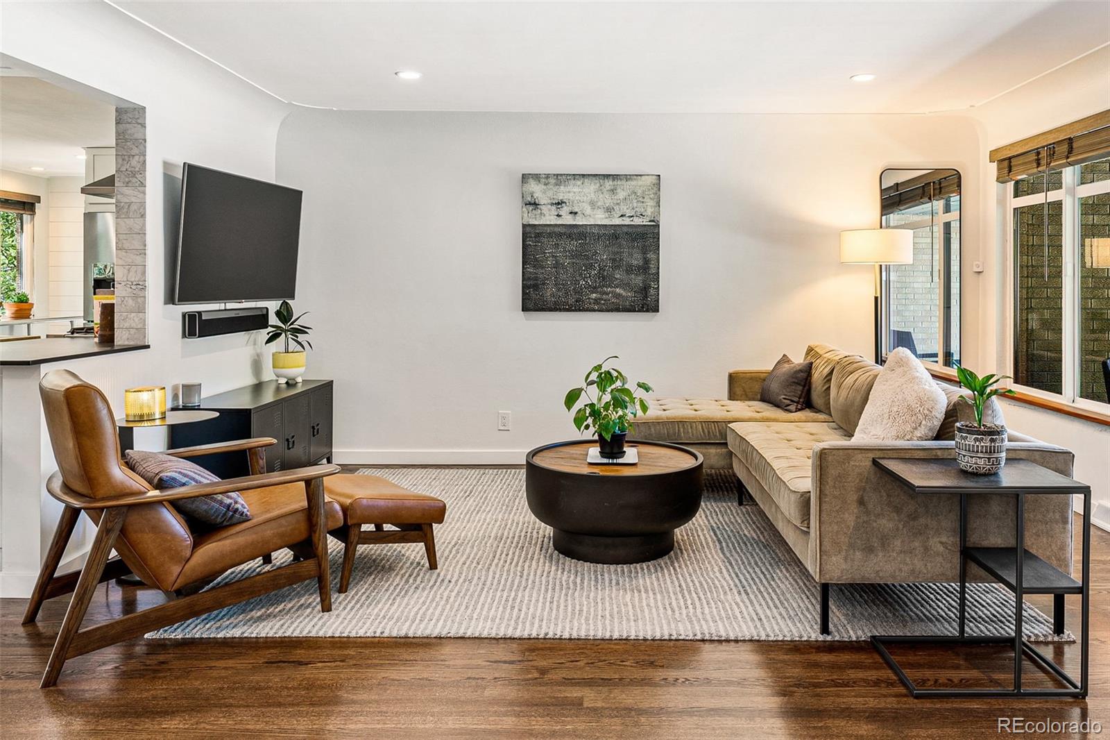 3885 Cody Street Wheat Ridge, CO 80033 - Photo 7 of 40 a living room with furniture and a flat screen tv