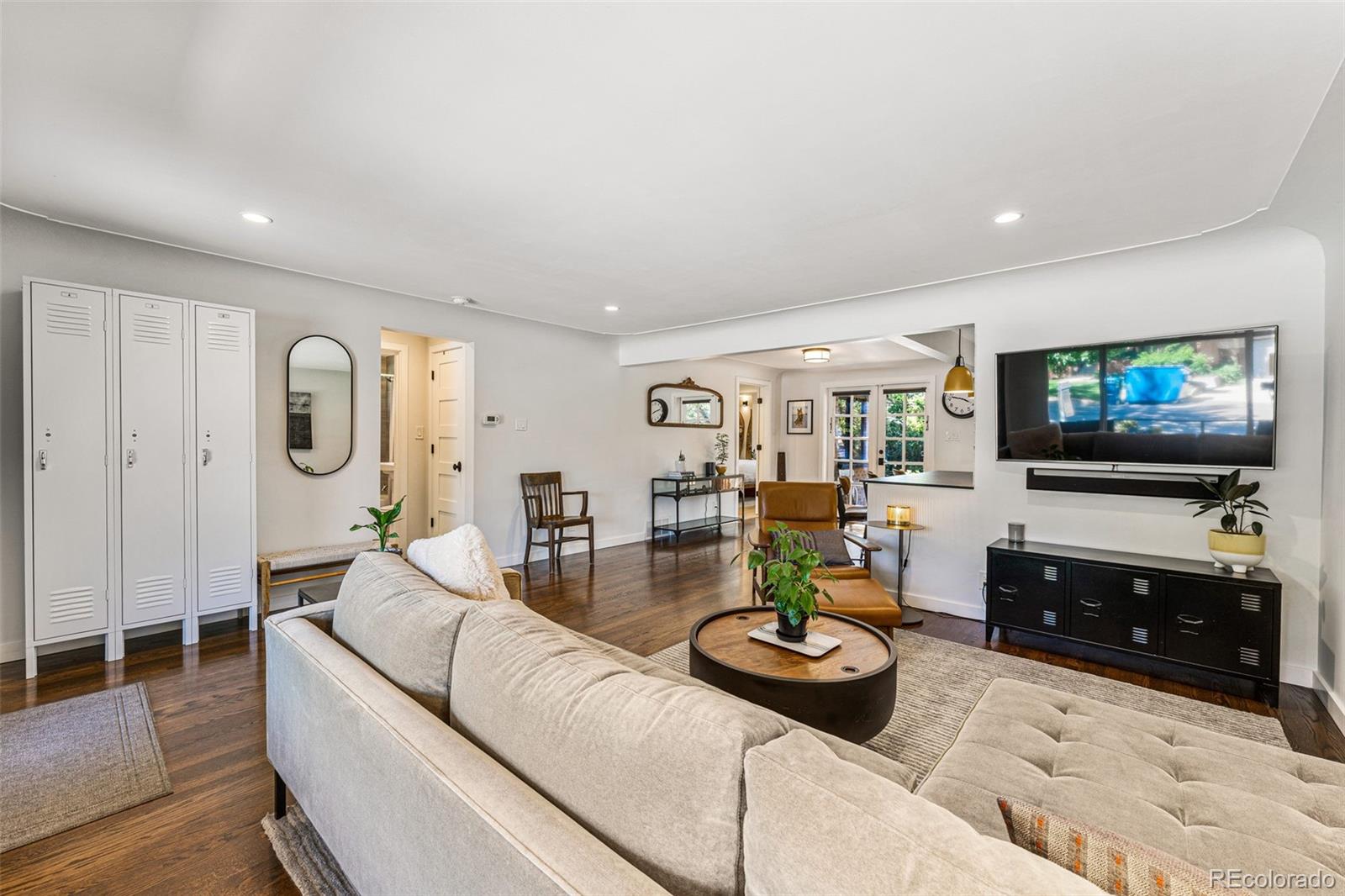 3885 Cody Street Wheat Ridge, CO 80033 - Photo 10 of 40 a living room with furniture and a flat screen tv
