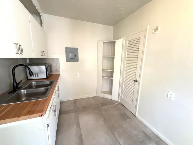 a kitchen that has a sink and a stove in it