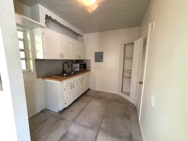 a kitchen with a sink a stove and cabinets