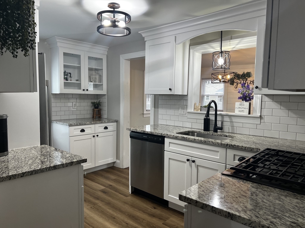 133 Winton Street Springfield, MA 01118 - Photo 5 of 17 a kitchen with stainless steel appliances granite countertop a sink stove and refrigerator