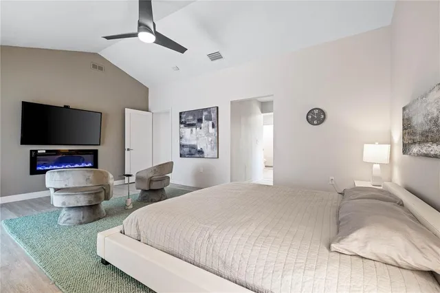 a view of a dining room with furniture one side kitchen view and wooden floor