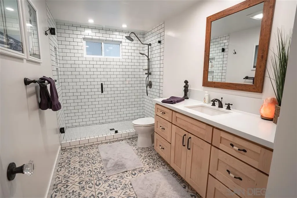 132 Candy Lane Encinitas, CA 92024 - Photo 12 of 24 a bathroom with a double vanity sink toilet and shower