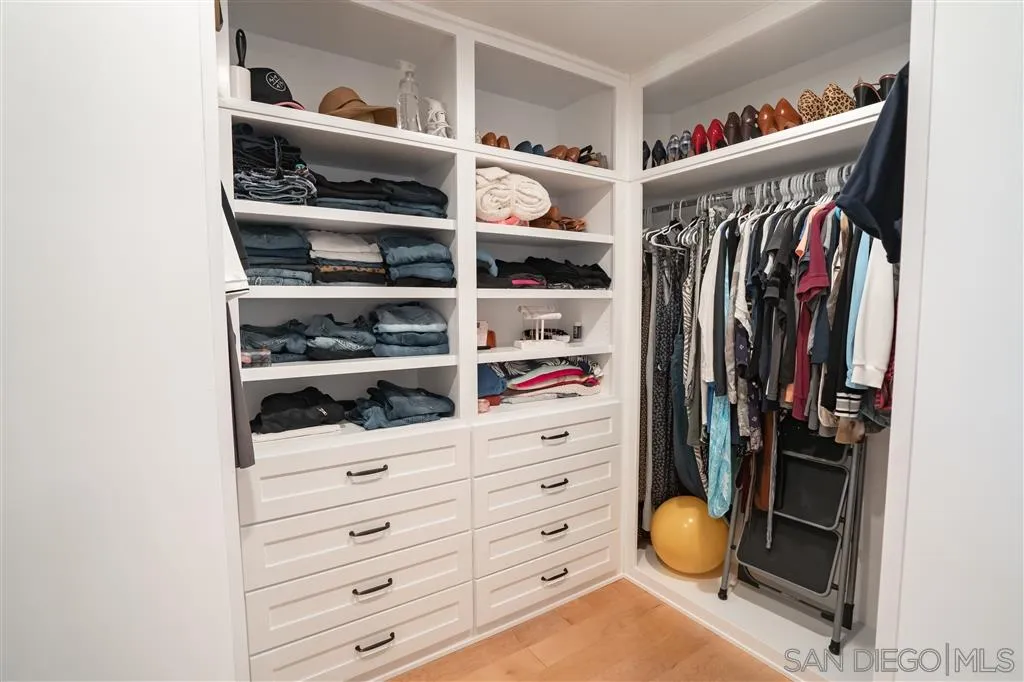 132 Candy Lane Encinitas, CA 92024 - Photo 8 of 24 a view of walk in closet with clothes and shoes