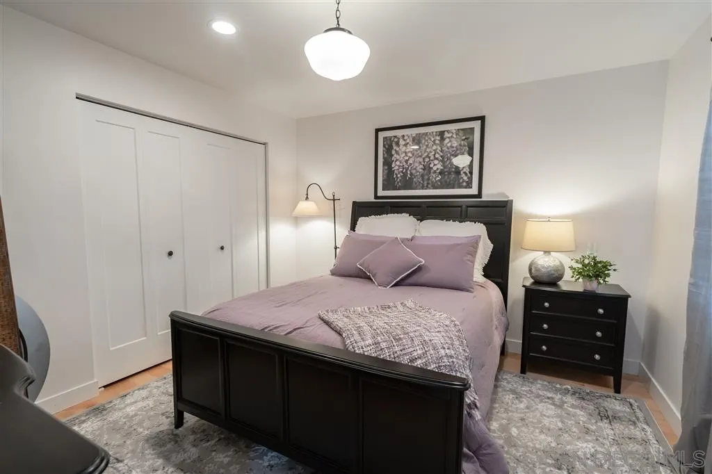 132 Candy Lane Encinitas, CA 92024 - Photo 9 of 24 a bedroom with a bed and a chandelier