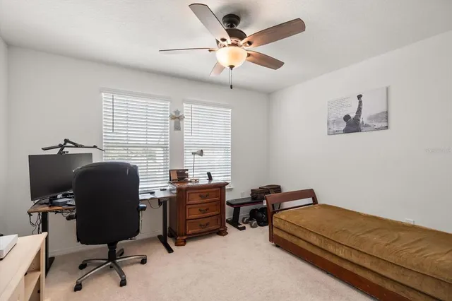 a bedroom with a workspace