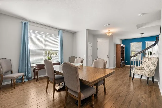 a view of a dining room with furniture and wooden floor
