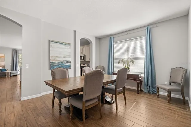 a view of a dining room with furniture window and wooden floor